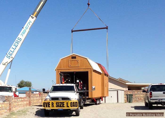Storage shed is brought in on a flatbed truck